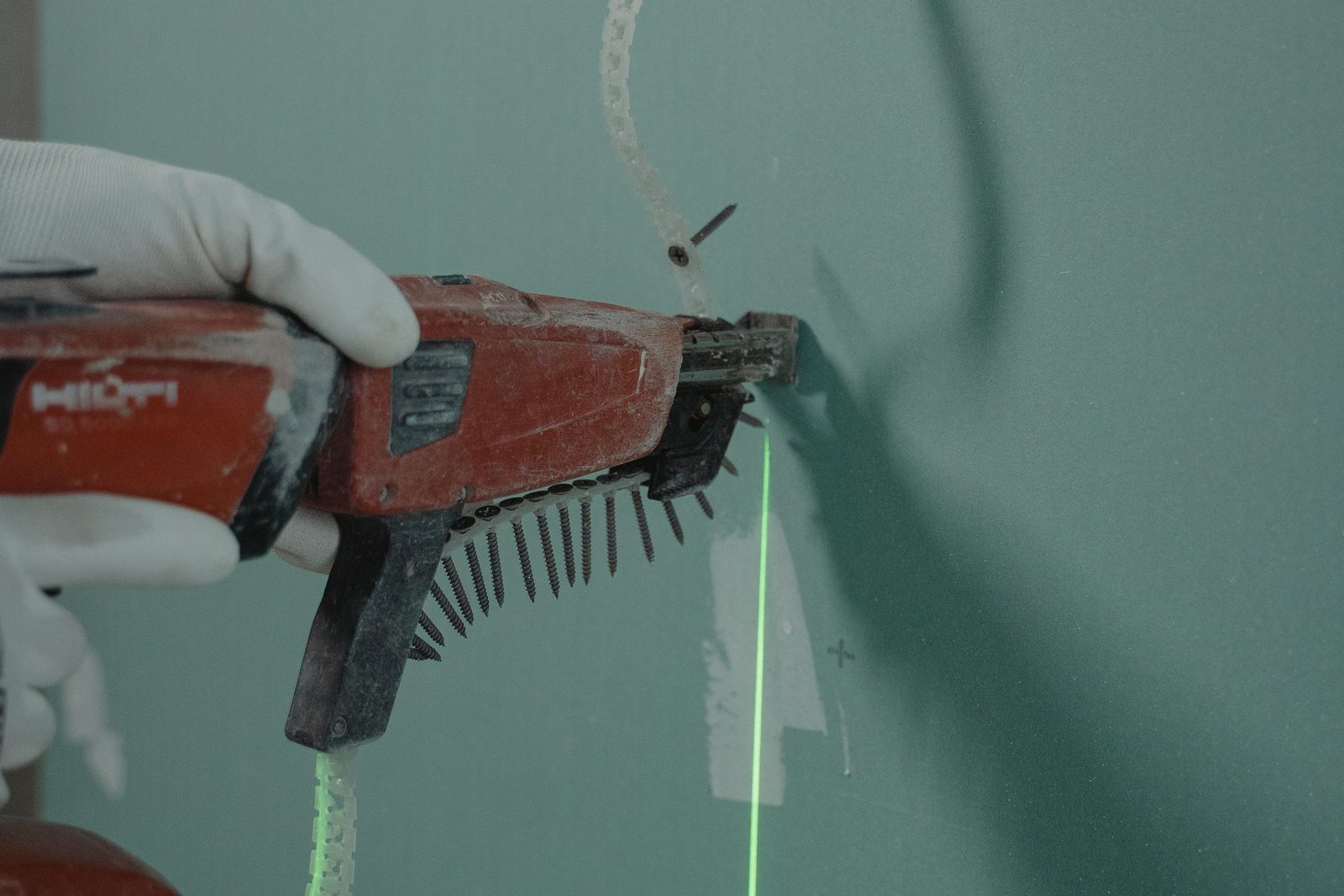 Plasterboard being fixed with a screw gun